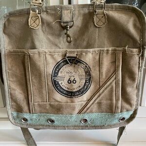 Trendy large Vintage Addiction cotton messenger bad in varied earth tones.